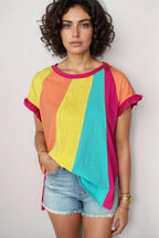 Woman wearing multicolored rainbow stripe t-shirt with ruffle sleeves and denim shorts