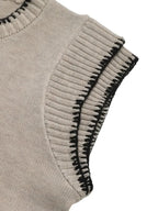 Light beige knit sleeveless top with ribbed edges and black contrast trim detail