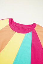 Colorblock short sleeve top with pink, blue, yellow and tan panels, round neckline
