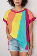 Woman wearing a colorful striped t-shirt with ruffle sleeves and light denim shorts